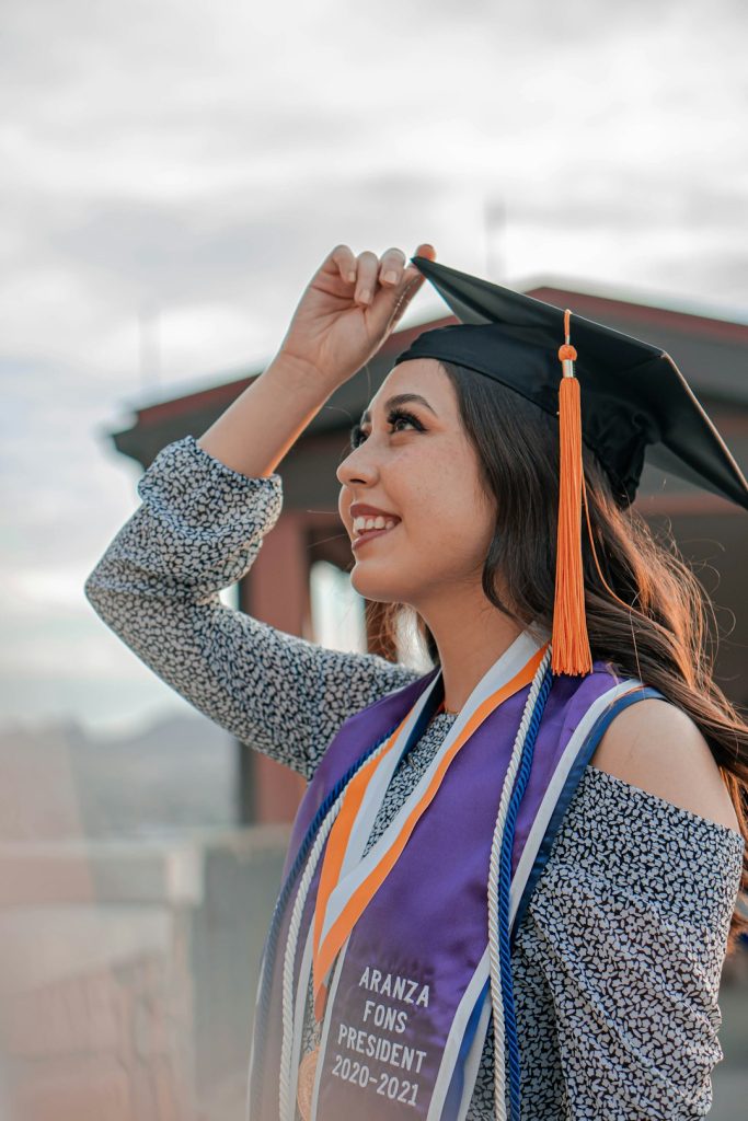 a-woman-in-a-graduation-cap-and-gown-gxd0wamg-fc
