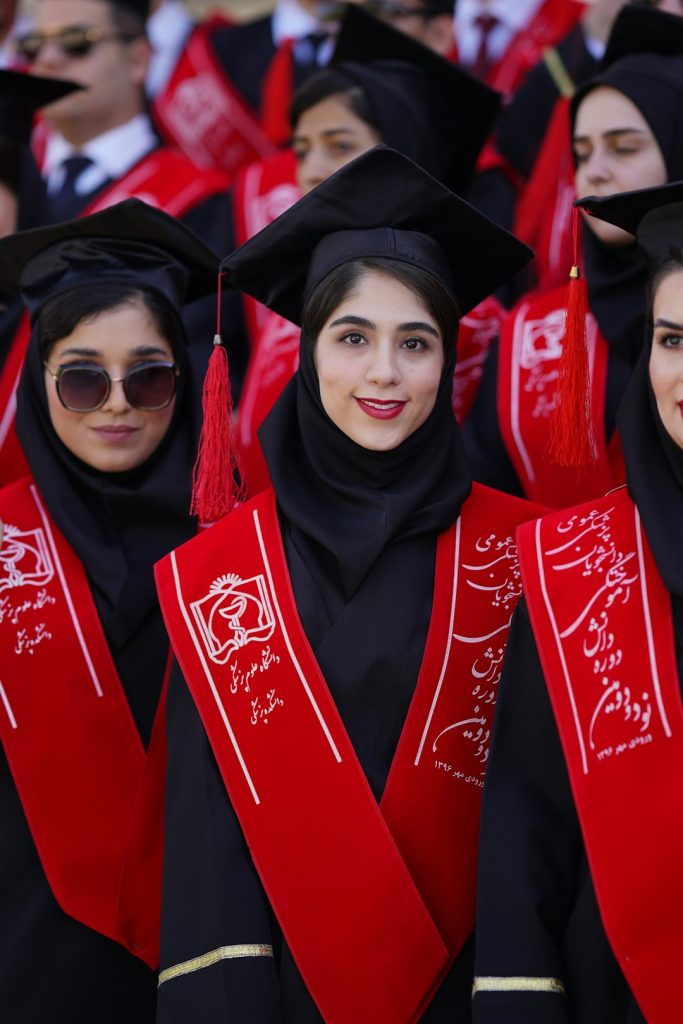 graduates-in-caps-and-gowns-celebrate-together-y6dovf-aswm